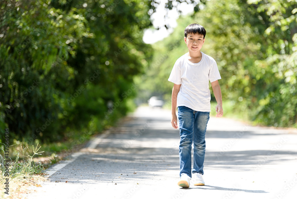 Fototapeta premium Boy walk on the road