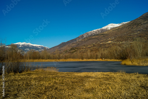 mountain panorama, with frozen lake, trees and forest