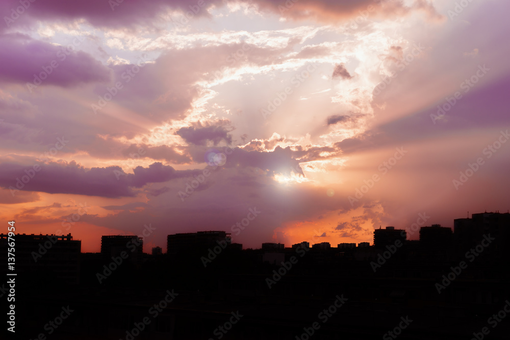 City landscape. Bright sunset over an evening city. Bright abstract background ideal for any design