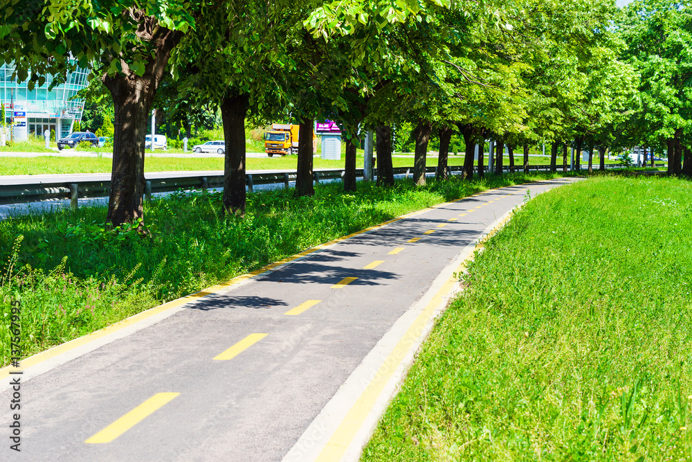 City landscape. Bicycle road in the city park. Sign showing bike path