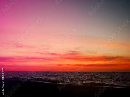 Orange and pink sunset sky over the beach