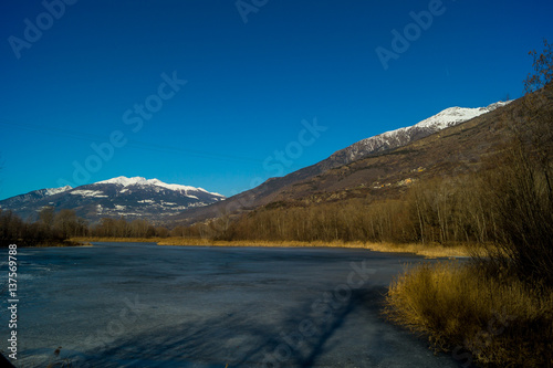 mountain panorama, with frozen lake, trees and forest