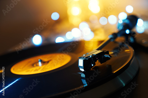 Blurred detail of a gramophone and record to listen to. Included gramophone and the torque plate close-up on a bright background