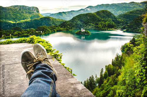 crossed feet lake aerial bled slovenia relax travel