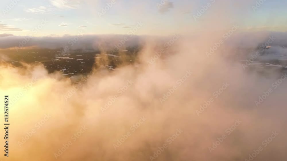 Volcano in the clouds. Flying in the clouds. Kamchatka on the sunset Volcano in the clouds. Flying in the clouds. Kamchatka on the sunset