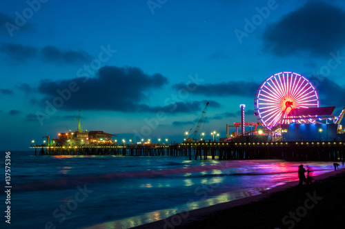 Amusement park on the pier in Santa Monica at night, Los Angeles, California, USA photo