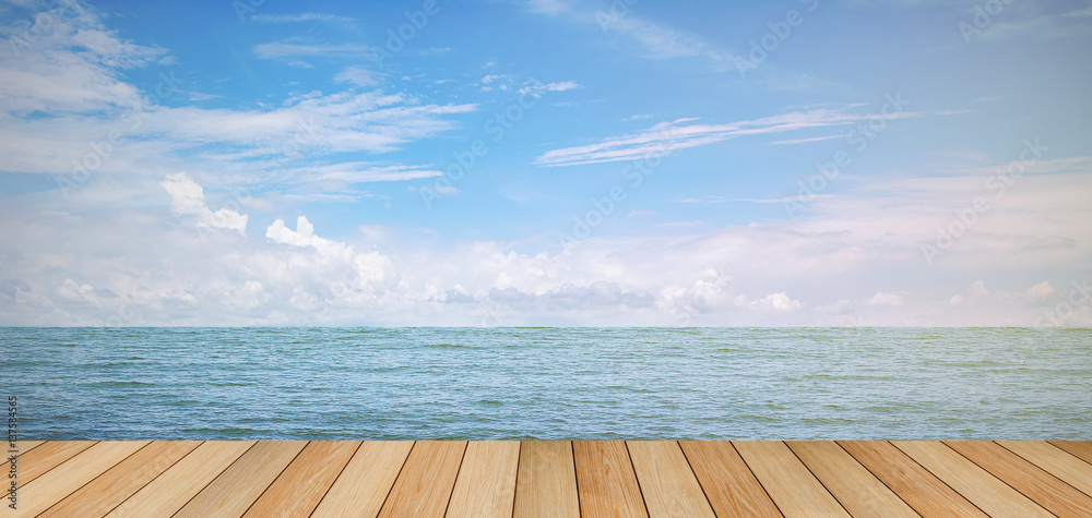 Fototapeta premium pier wood floor beside sea with blue sky background. summer relaxing time.