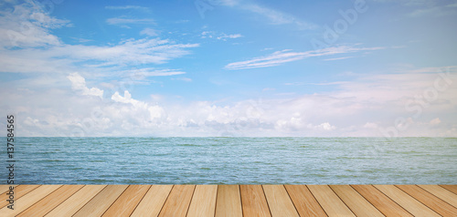 pier wood floor beside sea with blue sky background. summer relaxing time.