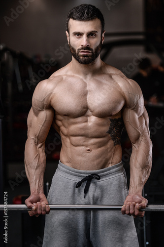 Handsome fitness model train in the gym gain muscle. © antondotsenko