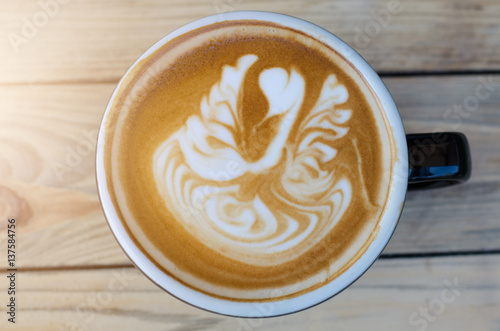 latte art coffee on wooden table