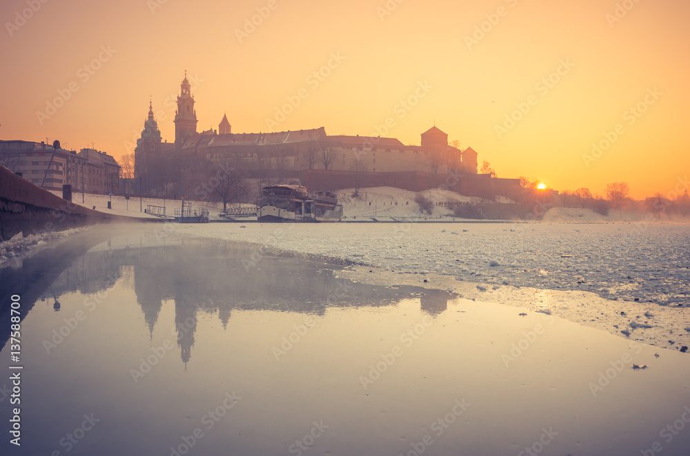 Krakow, Poland, Wawel Castle and Wawel cathedral  in the winter over frozen Vistula river in the morning