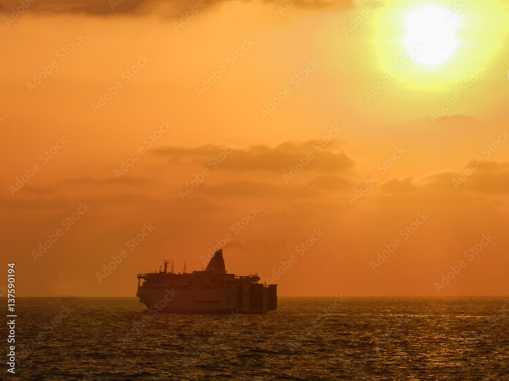 Silhouette :Cruises sail at sea. The sun is below the horizon.