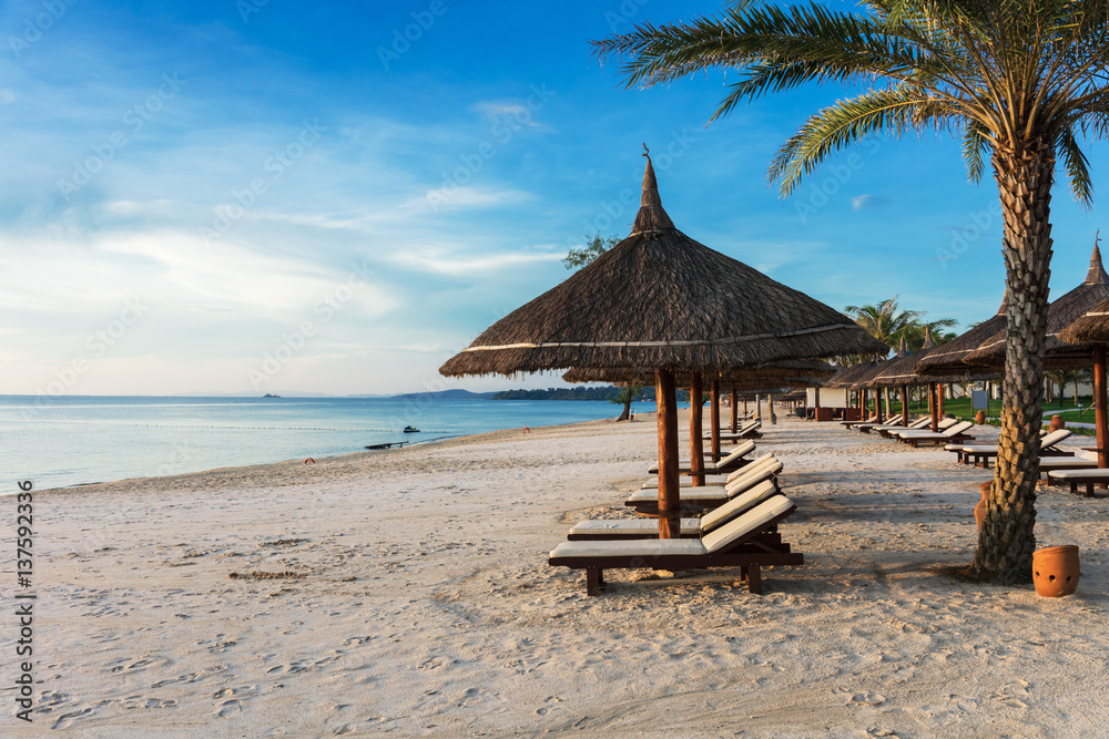 sun loungers and parasols on sandy beach sun loungers and parasols on sandy beach