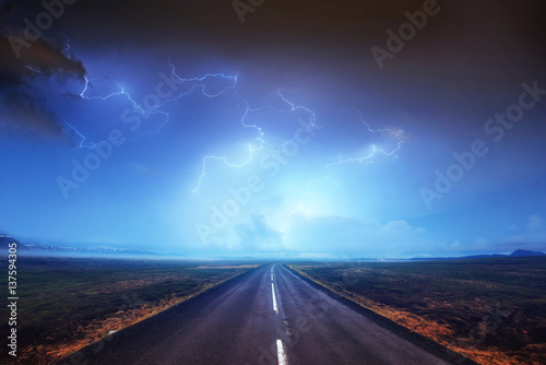 Fototapeta Naklejka Na Ścianę i Meble -  Lightning in cloudy dark sky and beautiful Asphalt road. Annual 