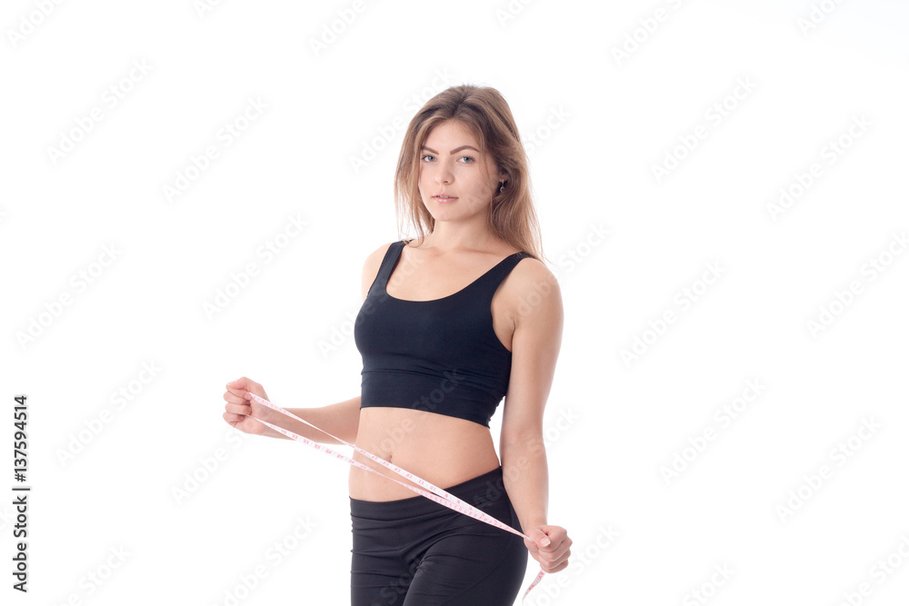 slender girl in black tights and top side which is holding tape measure slender girl in black tights and top side which is holding tape measure