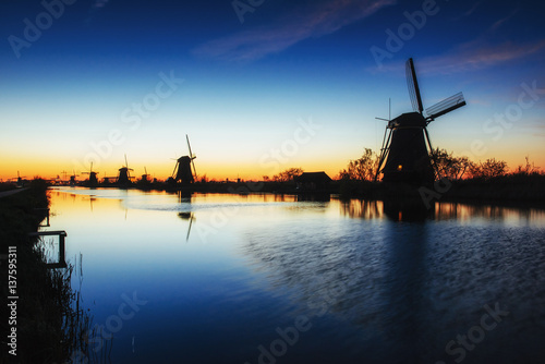 Fantastic sunset traditional Dutch windmills canal in Rotterdam.