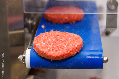 Hamburger meat on conveyor belt