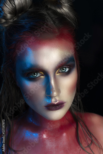Beauty close-up portrait of beautiful woman model face with magic creative fashion multicolored make-up. Face painting  cosmetics  beauty and makeup.
