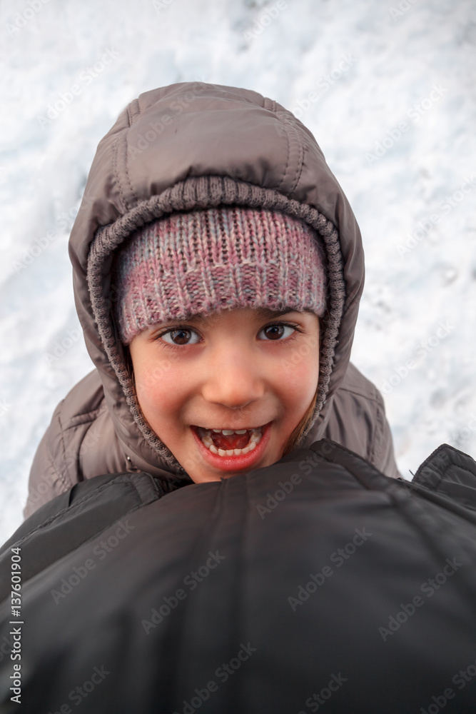 Child playing with parent in snow Child playing with parent in snow