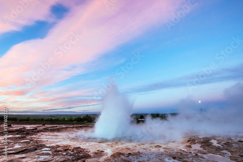 Strokkur geyser eruption in Iceland. Fantastic colors shine thro
