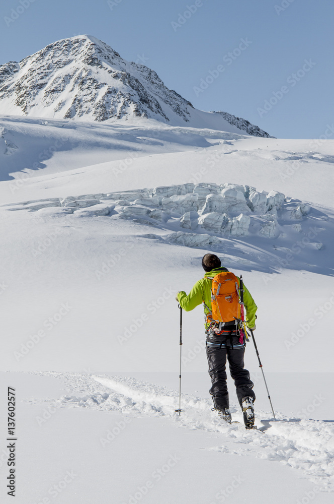 Back country skier ploughing through snow, European Alps, Tyrol, Austria Back country skier ploughing through snow, European Alps, Tyrol, Austria