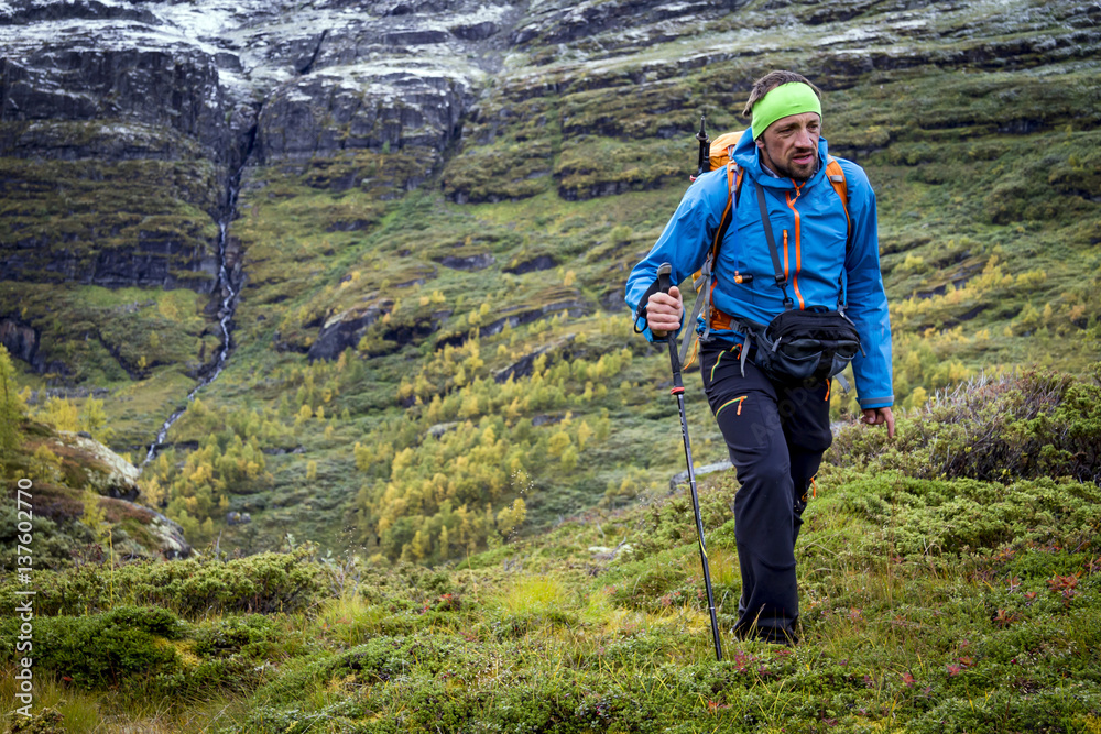 Man speed hiking along mountain trail, Norway, Europe Man speed hiking along mountain trail, Norway, Europe
