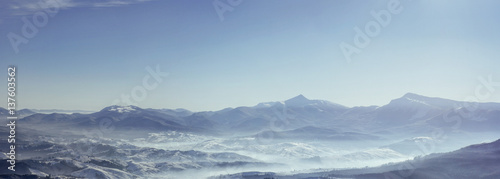 Snowy mountains peaks with mist at sunny day. Carpathian © standret