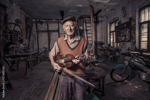 Senior violin maker in his workshop