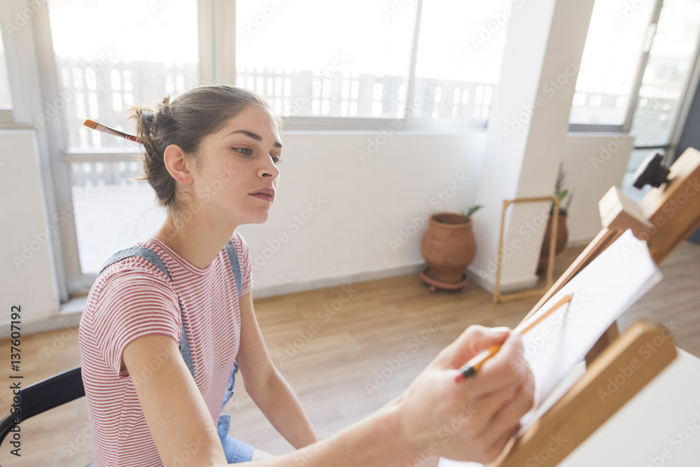 young woman artist drawing with pencil young woman artist drawing with pencil