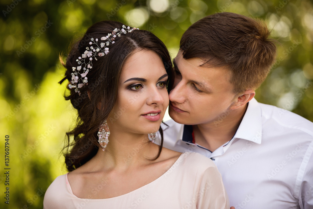Portrait of fashion couple, close-up faces of beautiful woman and man with tanned skin Portrait of fashion couple, close-up faces of beautiful woman and man with tanned skin