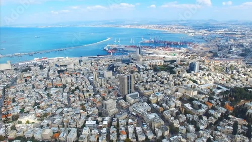 Aerial footage of the city of Haifa, Israel over the slope of mount Carmel