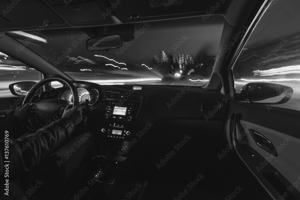 Car speed night drive on the road in city, black-and-white photo