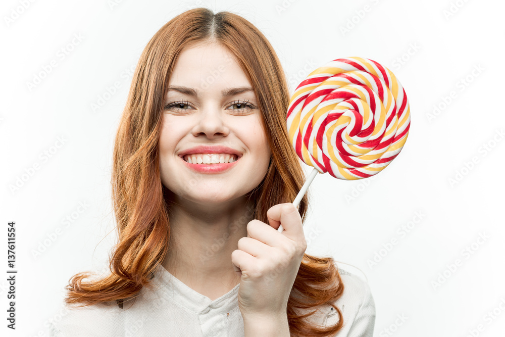 happy woman shows round lollipop