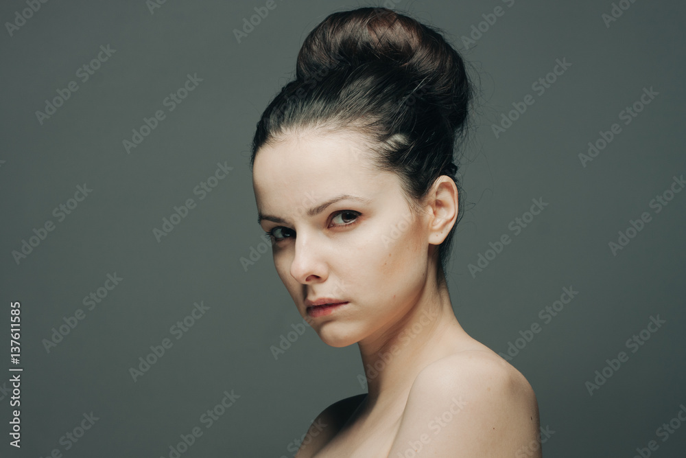 beautiful woman on a gray background, side view beautiful woman on a gray background, side view