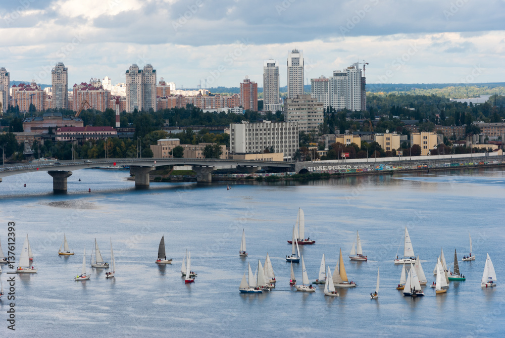View of sailing yachts regatta on Dnepr the river near the bridge, Kiev, Ukraine