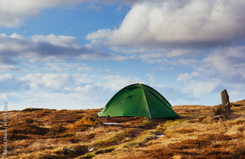 The tent is made up of green in the Carpathians. Spring mountain