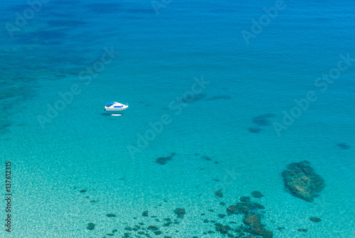 Panoramic view of a turquoise blue lagoon and a boat from mountain near the Latchi port, Cyprus. Cyprus sea view landscape.