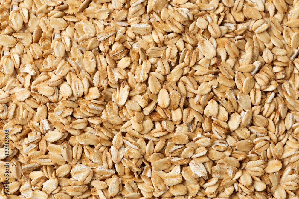 Oatmeal raw flakes close up textured background. Oatmeal raw flakes close up textured background.