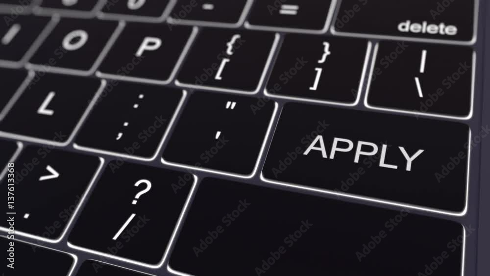 Dolly shot of black computer keyboard and glowing apply key. Conceptual 4K clip