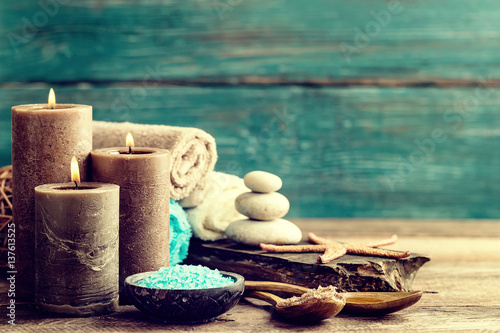 Set for spa treatments with cosmetic products for body care and relaxation on wooden background with space for a text