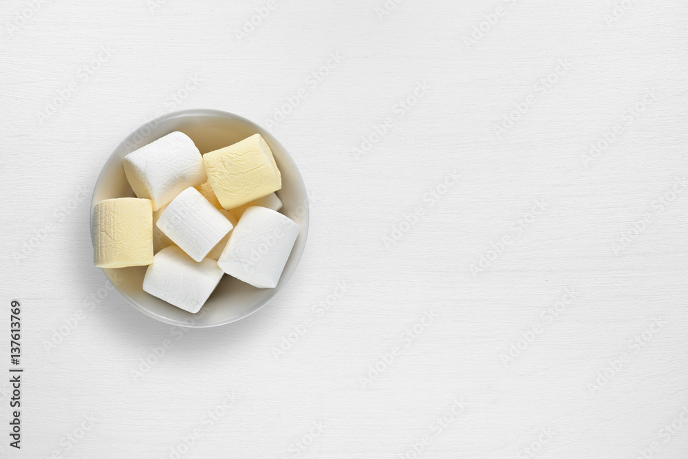 Marshmallow in bowl on white table Marshmallow in bowl on white table