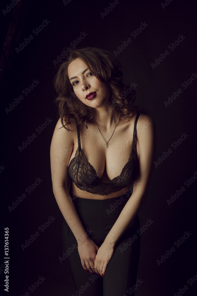 Brunette young woman in lace lingerie in the shadows Brunette young woman in lace lingerie in the shadows