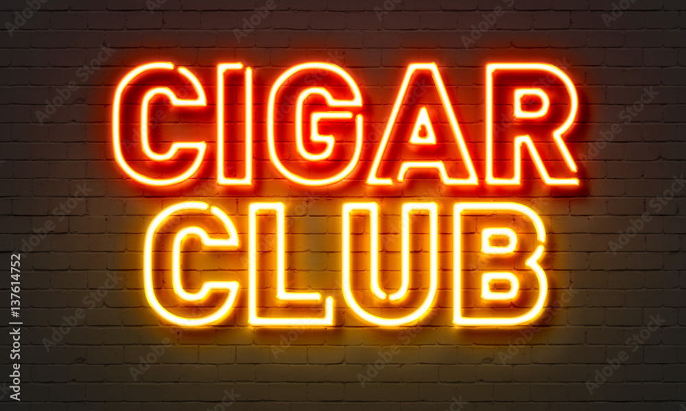 Cigar club neon sign on brick wall background.