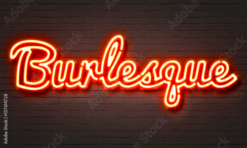 Burlesque neon sign on brick wall background. photo