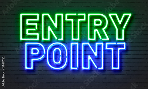 Entry point neon sign on brick wall background.