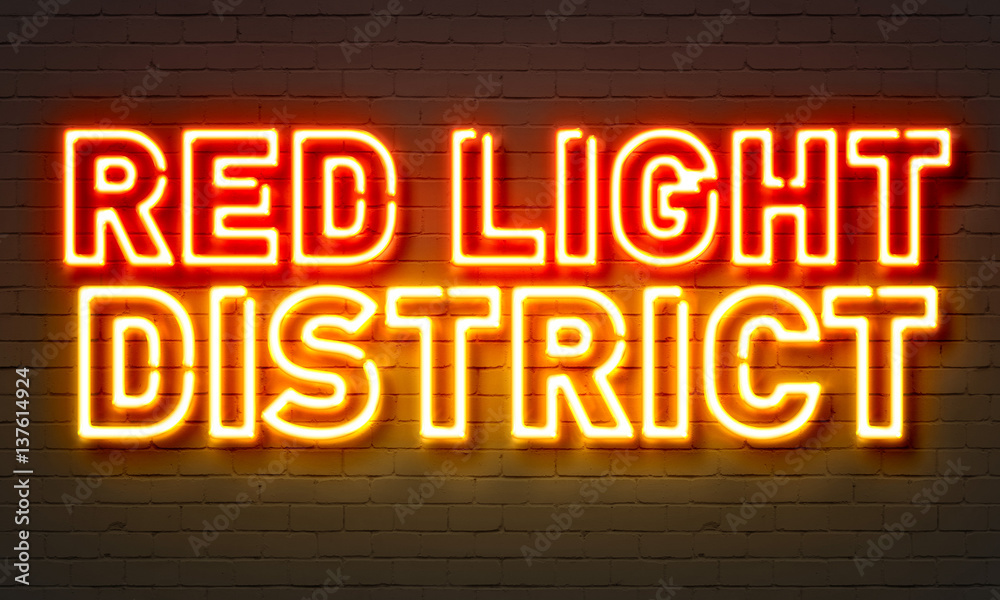 Red light district neon sign on brick wall background. Red light district neon sign on brick wall background.