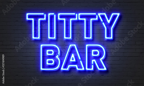 Titty bar neon sign on brick wall background.