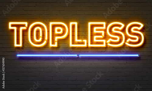 Topless neon sign on brick wall background. photo