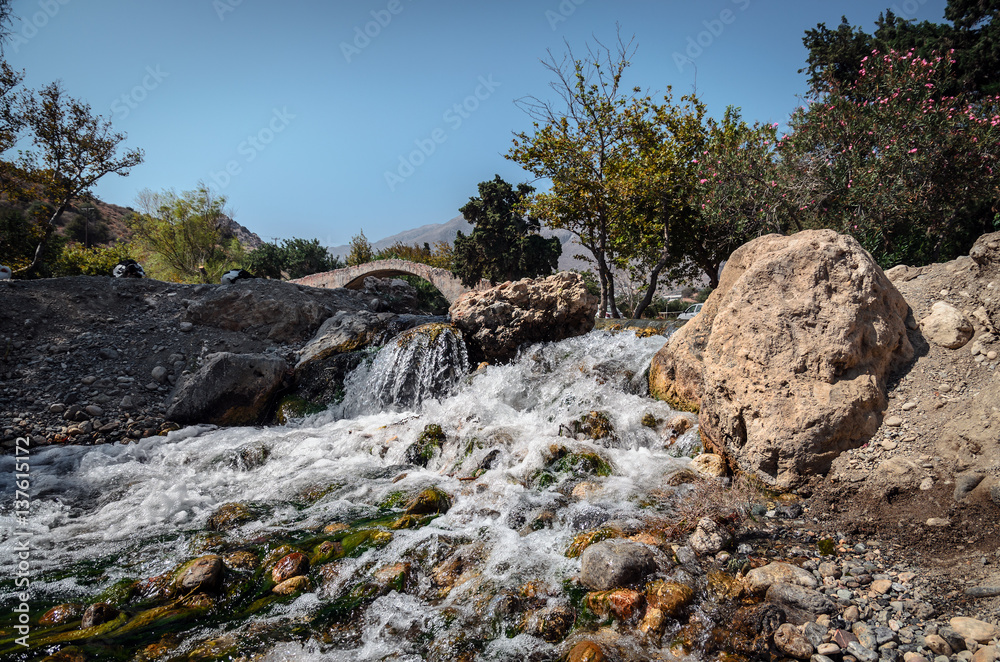 Small waterfall and old arch on a background in Preveli, Crete island