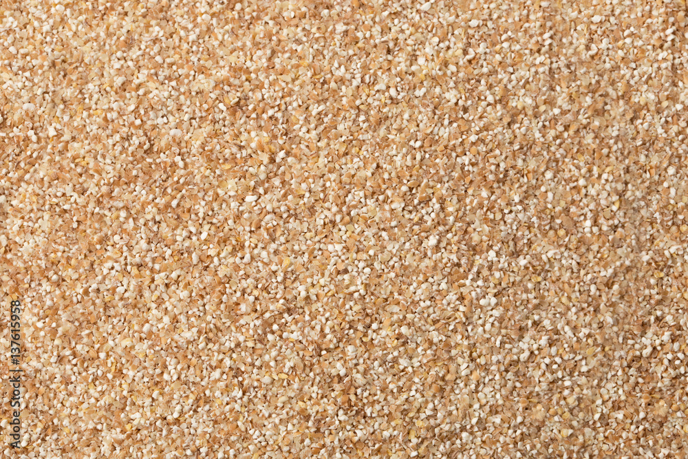 texture of raw wheat grits background. flat lay. texture of raw wheat grits background. flat lay.